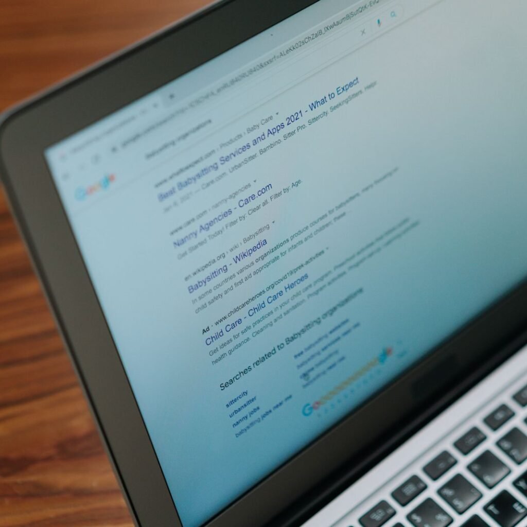 A close-up view of a laptop displaying a search engine page.
