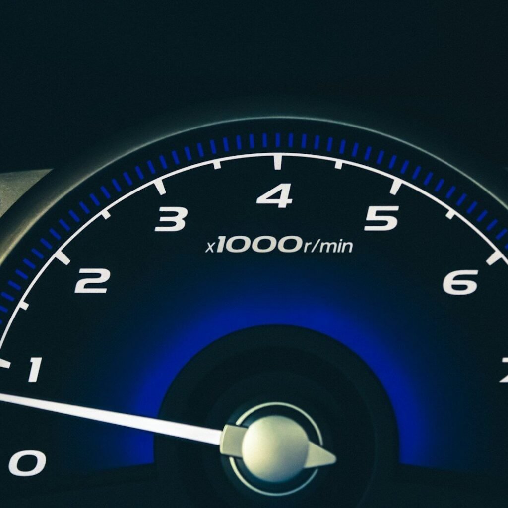 black and blue analog speedometer